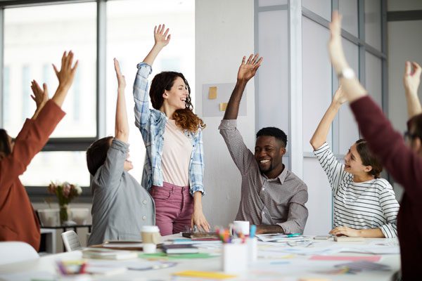 Diverse office team celebrates - Chad Weller (testimonials)
